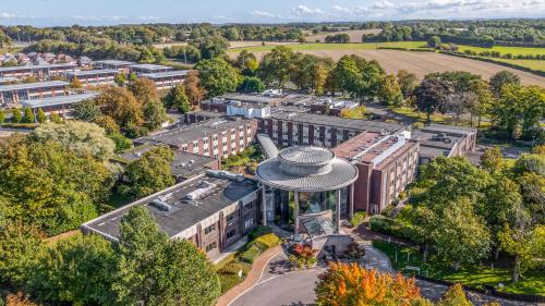 an overhead view of a city with buildings and trees at Daresbury Park Hotel in Daresbury