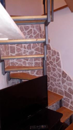 a computer sitting on a desk in front of a stone staircase at ToviMar Apartments in Taormina