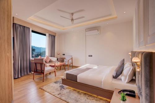 a hotel room with a bed and a dining room at Hotel Urban chant in Rishīkesh