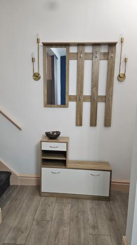 a bathroom with a vanity and a mirror on a wall at Jasmin's House, 3-bedroom entire house in Northampton