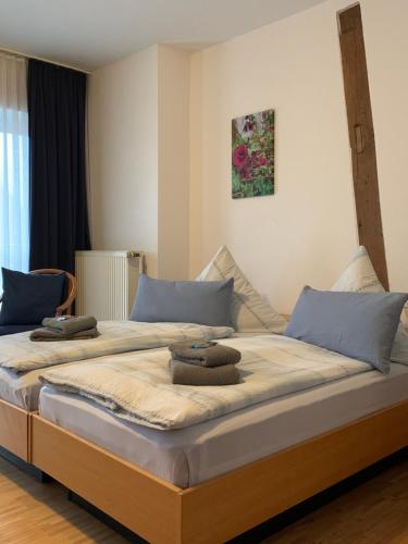 a bedroom with two beds with blue pillows on them at Landgasthaus-Hotel Wenninghoff in Dreierwalde