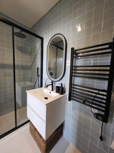 a bathroom with a white sink and a mirror at Villa Graça Olhão in Olhão
