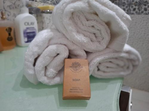 a pile of towels sitting on a counter with a card at Sultan Resorts 7 star Luxurious accommodations 