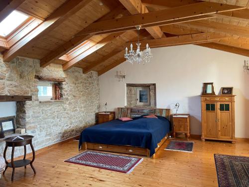 a bedroom with a bed and a stone wall at Terra Mirna - Urlaub für die Sinne in Vižinada