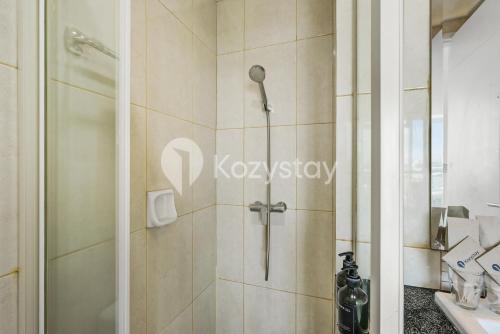 a shower with a glass door in a bathroom at Lily by Kozystay - Kuningan in Jakarta