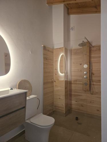 a bathroom with a shower and a toilet and a sink at ōku in Monchique