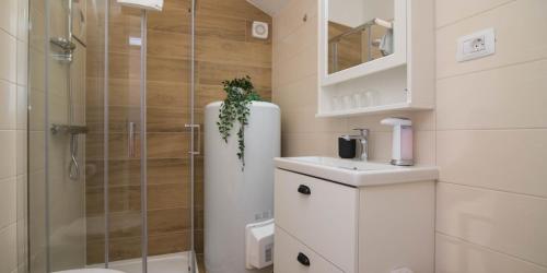a bathroom with a shower and a toilet and a sink at Pinea in Veli Lošinj