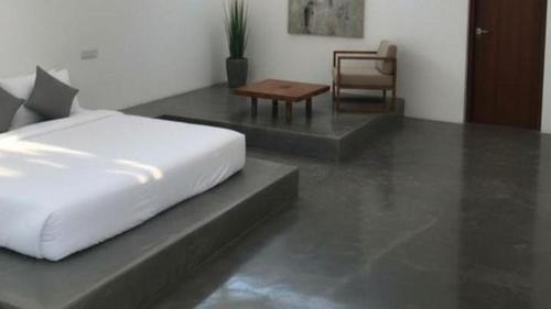 Un dormitorio con una cama, una mesa y una silla. en Sree Veda Wellness Resort, en Kuilapayam