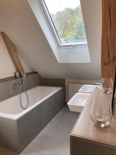 a bathroom with a bath tub and a window at Haus am Fluss in Bad Freienwalde