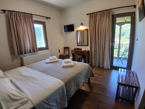 a bedroom with a bed with two towels on it at Αρχοντικό in Megalo Chorio