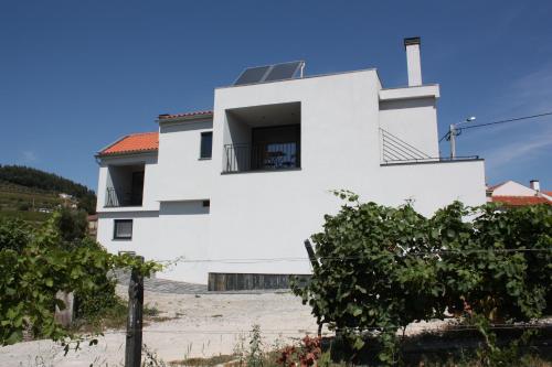 a white house on top of a hill at Casa Nª Sra. do Carmo - Villas in Peso da Régua