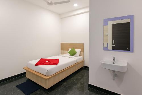 a bedroom with a bed and a sink with a red bow at Hotel Heaven Stay in Shankerpalli