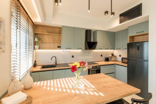 a kitchen with a table with a vase of flowers on it at Kyveli Lake Suite in Kastoria