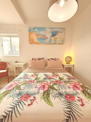 a bedroom with a large bed with a floral bedspread at APARTMENT IN AMARILLA GOLF 2 bedrooms in San Miguel de Abona