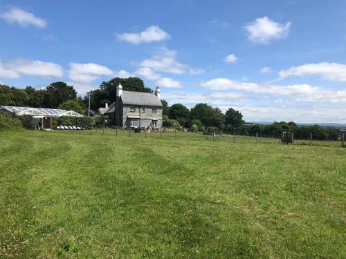 a large field with a house in the background at St Annes House Double Room 6 in Plymouth