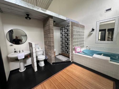 a bathroom with a sink toilet and a tub at Sunset Oaks Retreat Events, Farm Animals & Views in Saint Jo