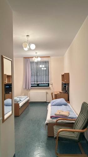 a bedroom with two beds and a mirror at Osiedle Studenckie w Słubicach in Słubice