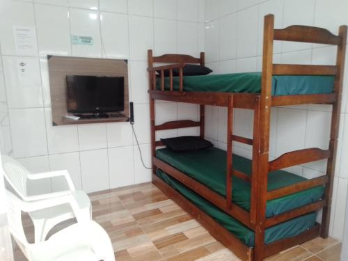 Una cama o camas en una habitación de Home Enseada Beach