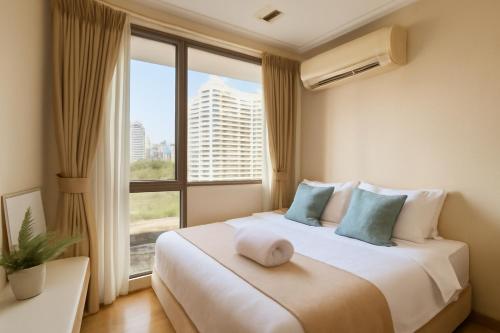 a bedroom with a large bed with a large window at City Center Nana 4-Guest Suite 100m Nana BTS in Bangkok