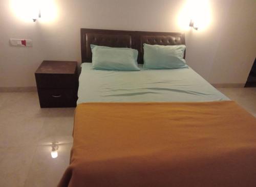 a bedroom with a large bed with two pillows at Budha Garden in Arambol