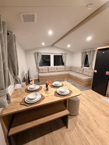 a living room with a table and a couch at St Marys View in Whitley Bay