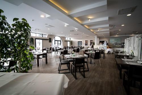 a restaurant with tables and chairs in a room at Hotel Villa Nečas Žilina in Žilina