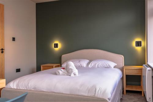 a bedroom with a bed with white sheets and pillows at Cosy serviced flat in Westbury on Trym in Bristol