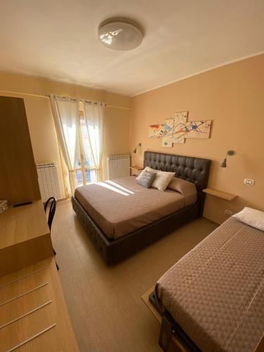 a bedroom with two beds and a couch in it at B&B La Margherita in Ateleta