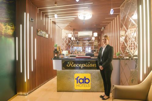 大诺伊达FabHotel Elegant Stay的女人站在餐馆前