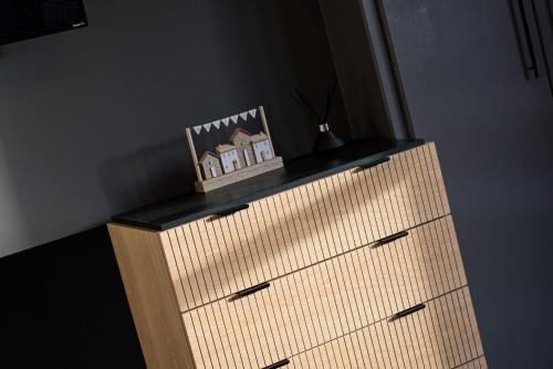 a wooden dresser with a picture on top of it at Rosemont ApartHotel in Leeds