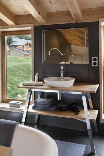 a bathroom with a sink and a mirror at Chalet Ana & SPA in Les Angles
