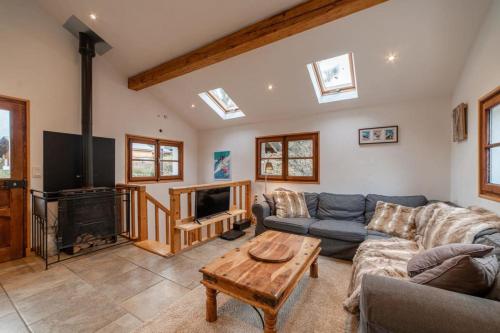 a living room with a couch and a fireplace at Charming Chalet With Garden In Les Houches in Les Houches