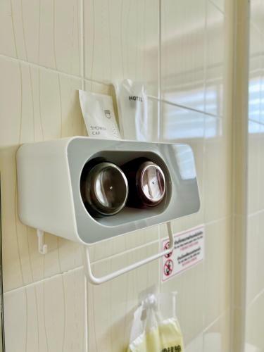 a security camera on the wall of a bathroom at Calm Stay & Cafe in Chiang Mai