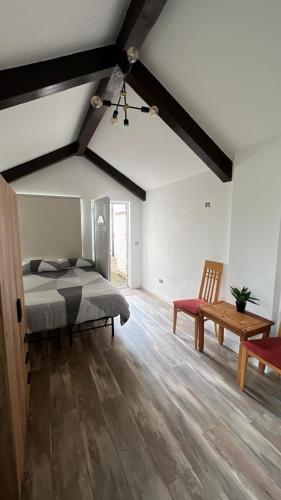 a bedroom with a bed and a table and a bench at Mountain lodge in Dundalk