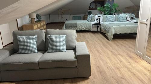 a living room with a couch and two beds at La Hondonada in Somo