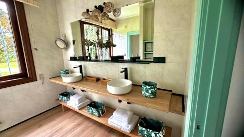 a bathroom with two sinks and a mirror at La Hondonada in Somo