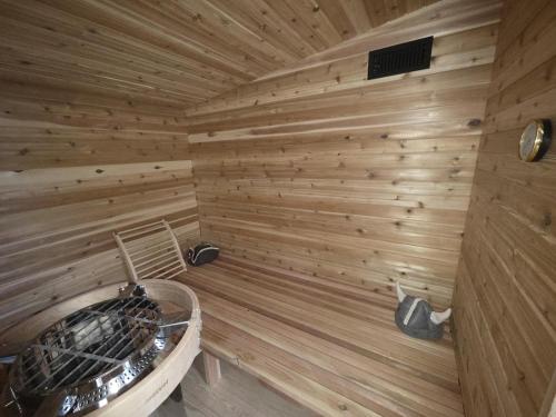 a wooden sauna with a wood paneled wall at This Deluxe Modern New 3-Story Home With Central Ac Offers The Best Of Bozeman! in Bozeman