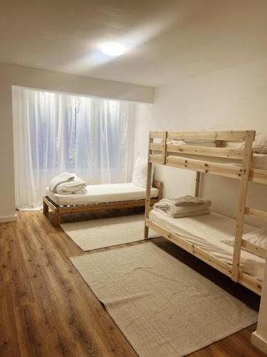 a bedroom with two bunk beds and a window at Emmas Apartments in Duisburg