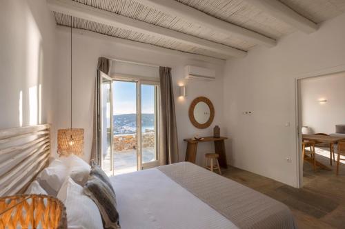a bedroom with a bed and a view of the ocean at New Project Fos in Platis Yialos Sifnos