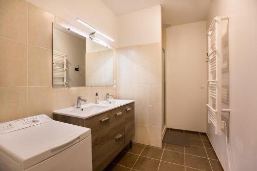 a bathroom with a sink and a mirror at Le chene vert in Saint-Front-de-Pradoux