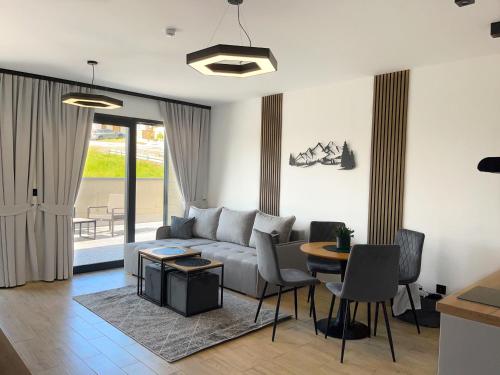 a living room with a couch and a table at Willa Pienińska 123 in Maniowy