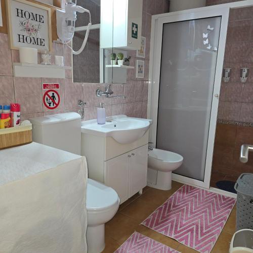 a bathroom with a sink and a toilet and a shower at Apartman Hersek Mostar in Mostar