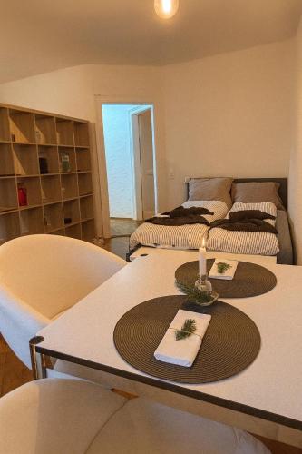 a room with two beds and a table with a candle on it at Cool and Laidback at Sankt Johann in Basel