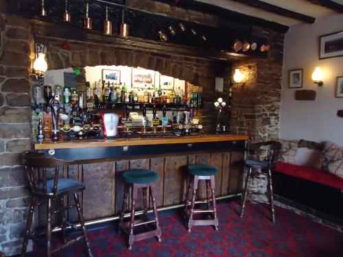 a bar in a pub with two stools at The Street Head Inn in West Burton