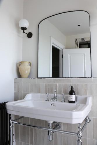a white sink in a bathroom with a mirror at Luxury Apartment in Shropshire sleeps 4 in Shrewsbury