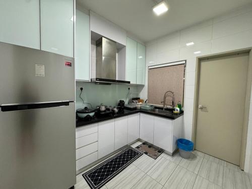 a kitchen with a sink and a refrigerator at Tea Valley & Farm View at Cool Summer Cameron in Cameron Highlands