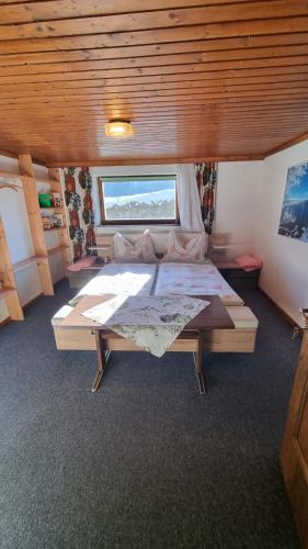 a large bed in a room with a large window at Peaceful Mountain Double Room in Kleinsonnberg