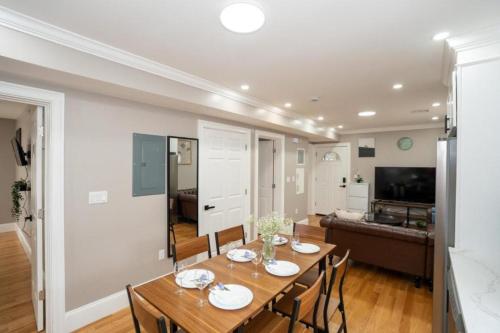 a dining room and living room with a table and chairs at 558-2 Boston - Spacious & Modern 3BR near Franklin Park in Boston