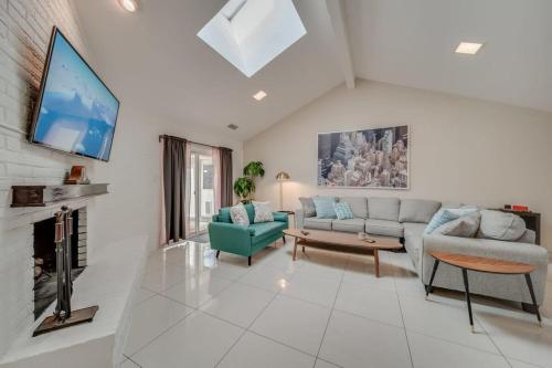 a living room with a couch and a tv at Central Plano 4-BD 2-BA Pool Retreat, Sleeps 10 in Plano