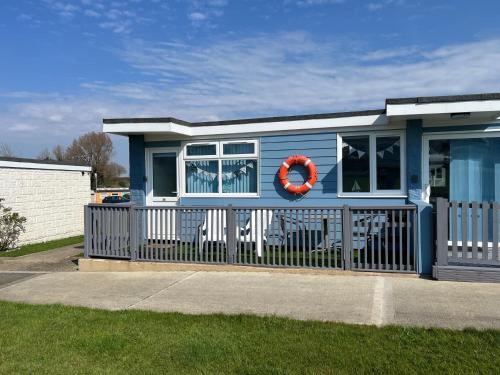 a blue tiny house with a red life preserver at Wight Waves Holidays in Sandown